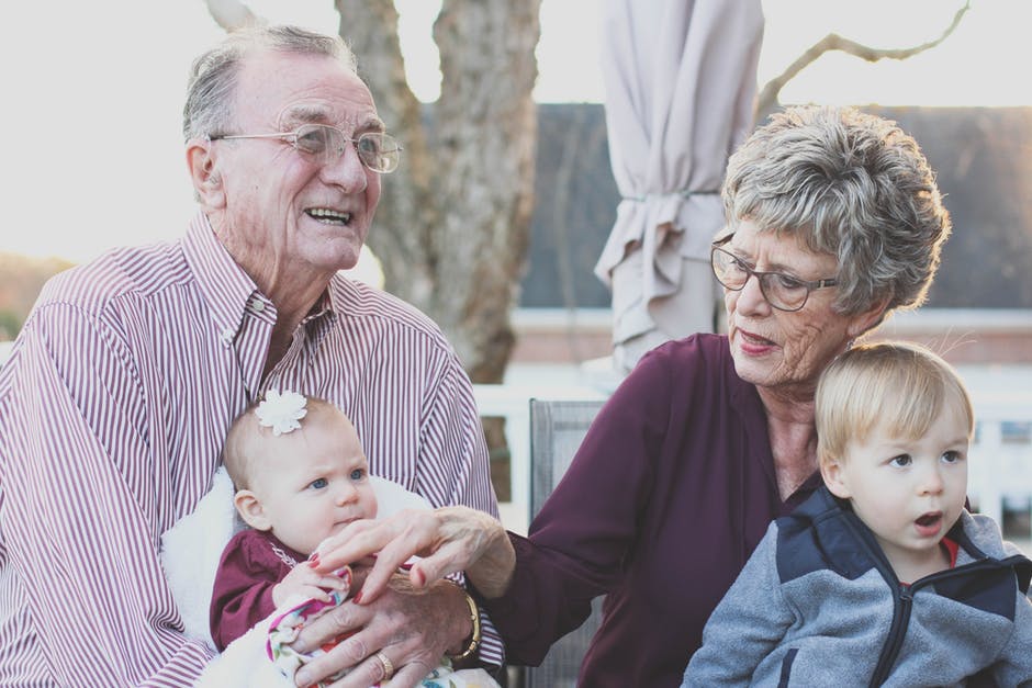 grands-parents avec leurs petits-enfants sur les genoux